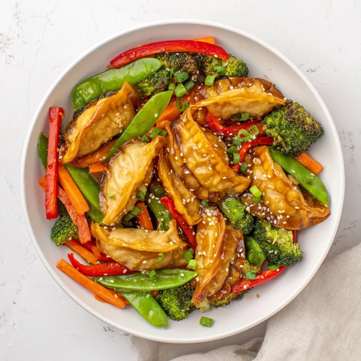 Tender dumplings and crisp veggies tossed in rich garlic sauce over a dark skillet