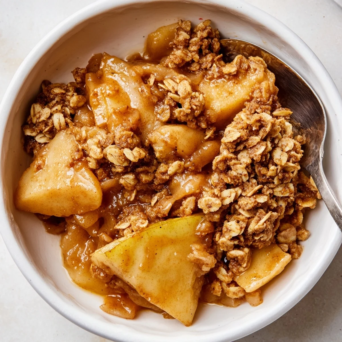 Warm crockpot apple crisp with tender cinnamon apples and golden oat topping in a slow cooker