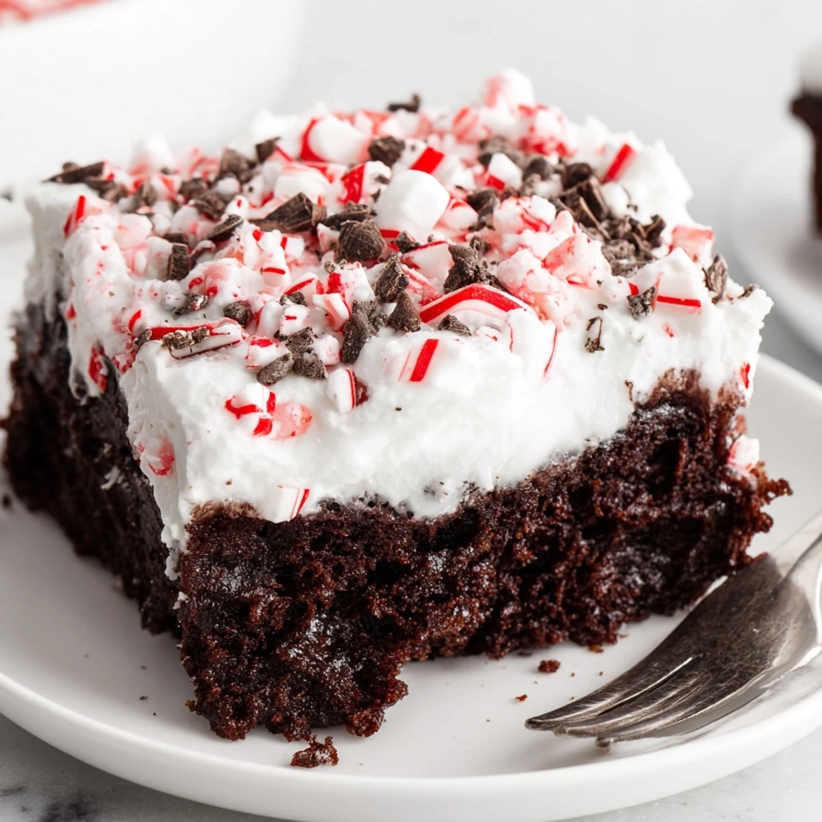 Peppermint Poke Cake sliced on festive platter, creamy mint filling visible