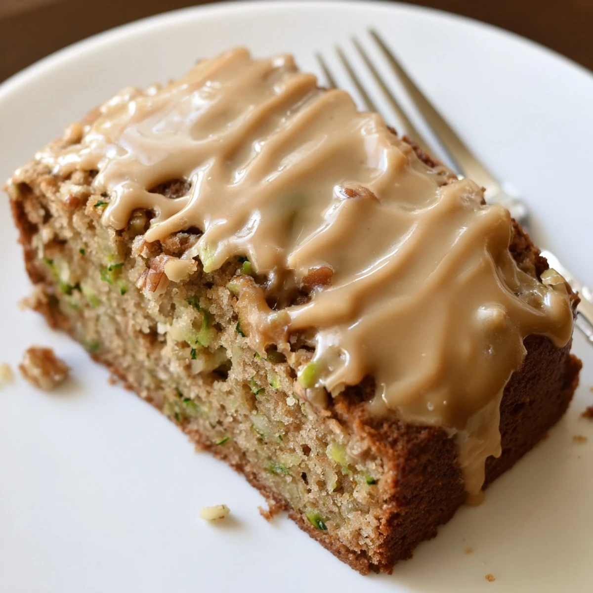 Zucchini Cake With Brown Sugar Icing, moist slices glistening with buttery glaze.