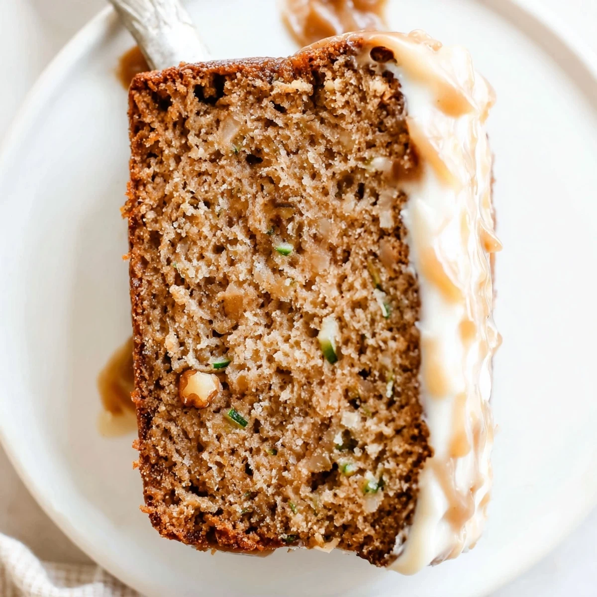 Sliced Zucchini Cake With Brown Sugar Icing shows tender crumb, cinnamon aroma.