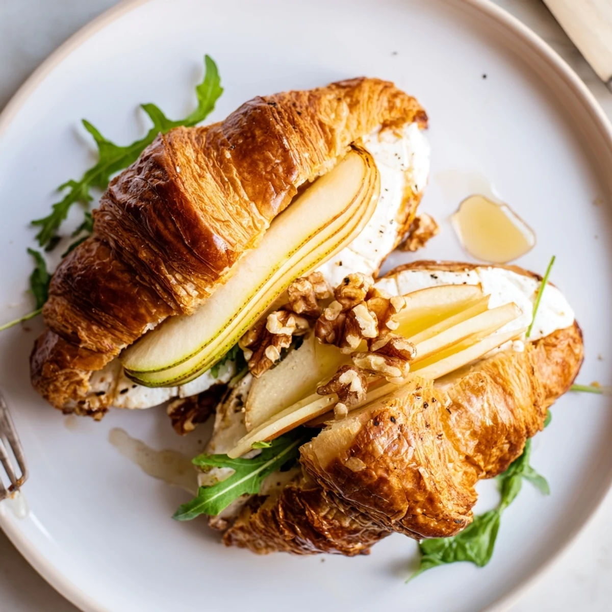 Toasted Apple Goat Cheese Croissant Sandwich with arugula, walnuts for crunchy brunch bite