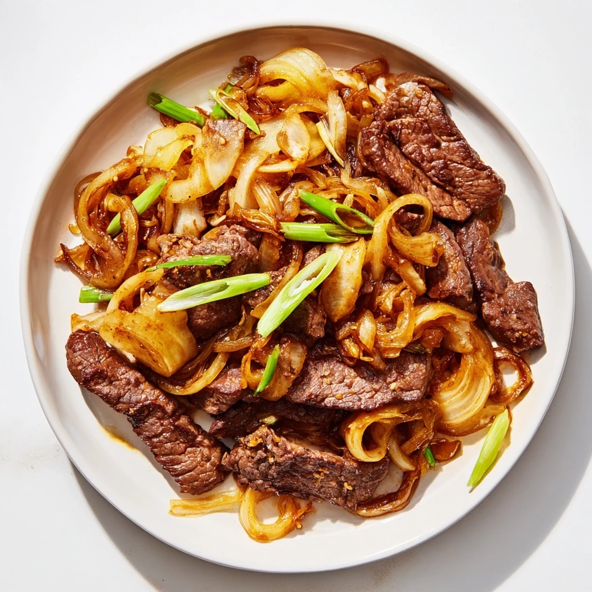 Sizzling wok full of tender crispy beef strips and sweet onions glazed in savory brown sauce