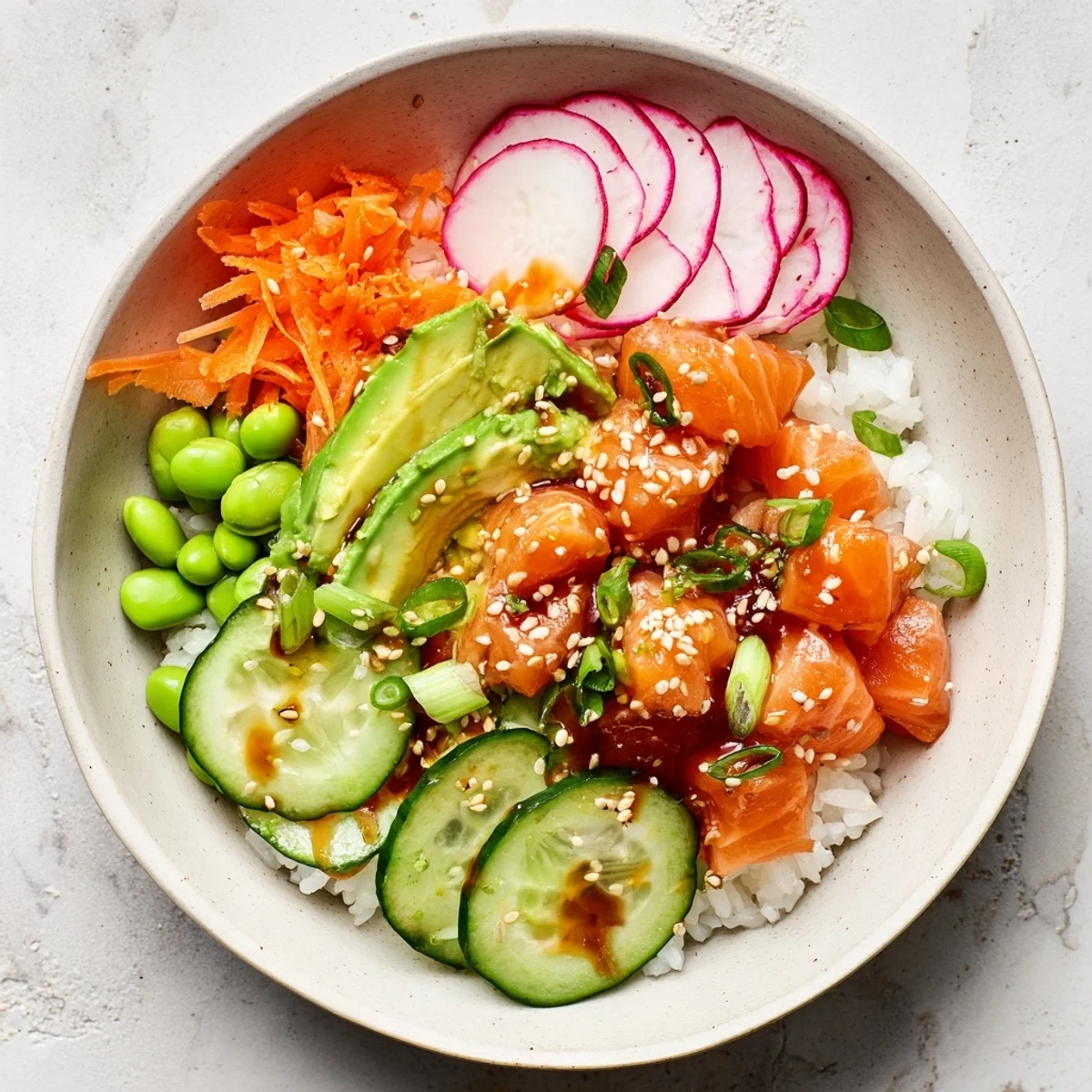 Colorful salmon and avocado poke bowl with fresh vegetables over seasoned rice