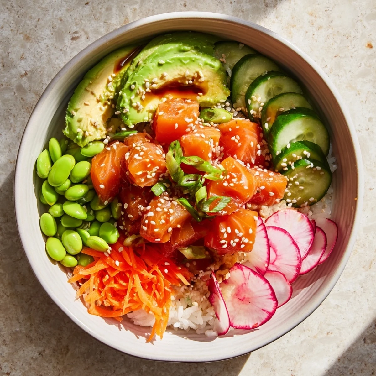 Healthy salmon and avocado poke bowl topped with crisp vegetables and sesame seeds