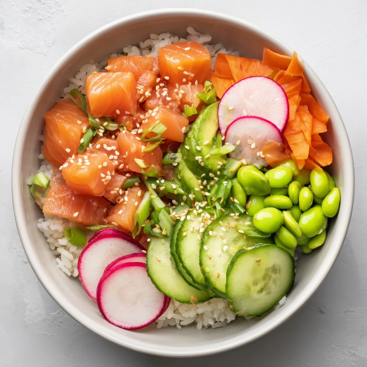 Fresh diced salmon and creamy avocado arranged in a vibrant Hawaiian-style poke bowl