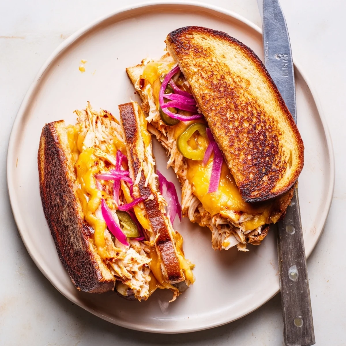 Golden BBQ chicken grilled cheese sandwich with melted cheddar and sourdough bread