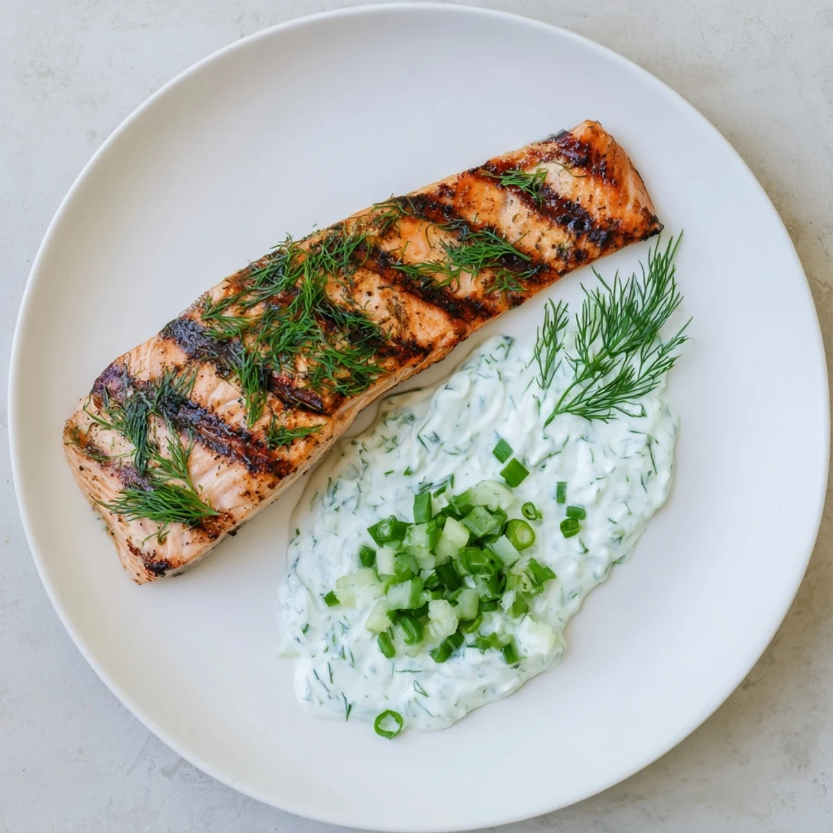 Lemon herb grilled salmon plated with zesty marinade and fresh herb garnish