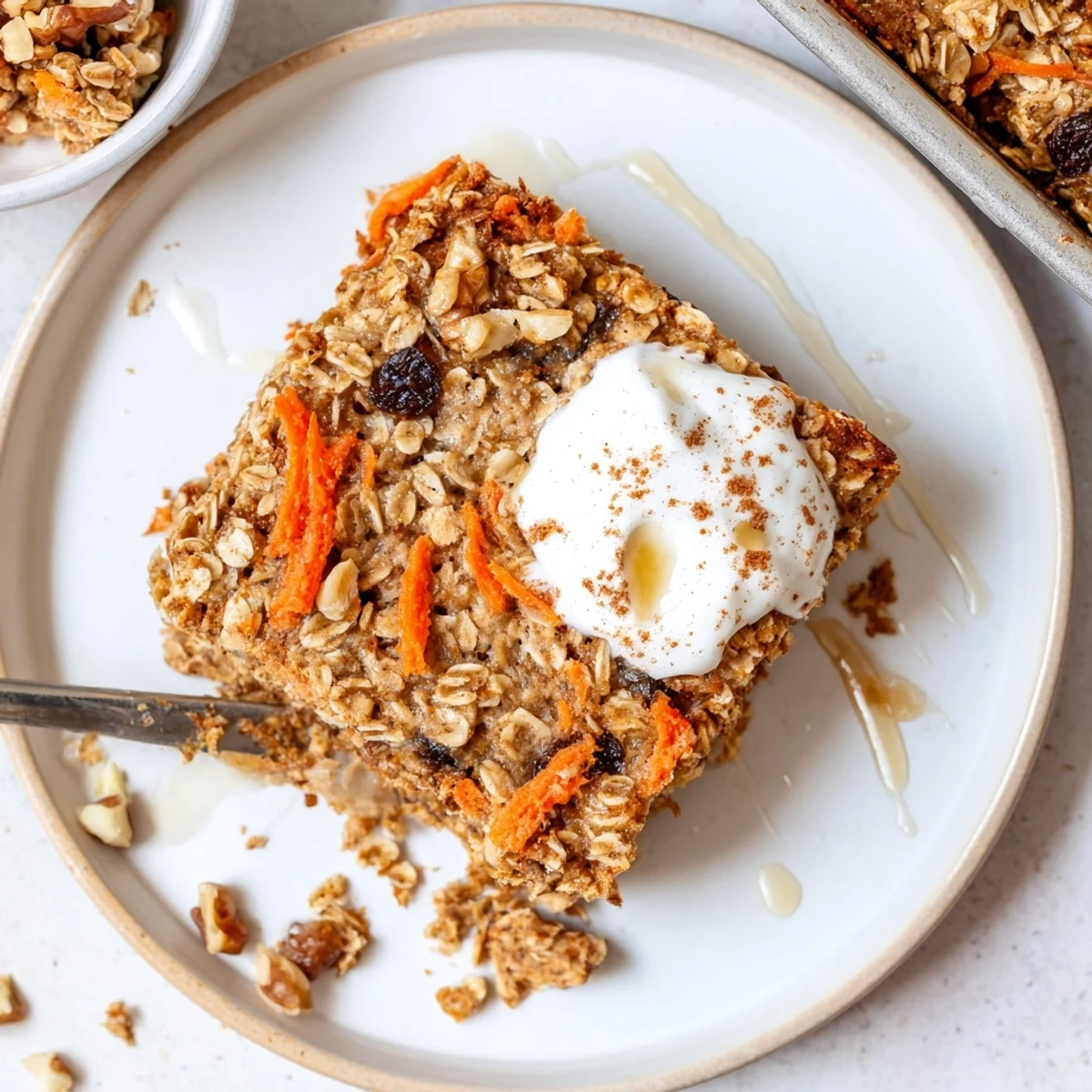 Sliced Carrot Cake Baked Oatmeal served warm with creamy yogurt dollop.