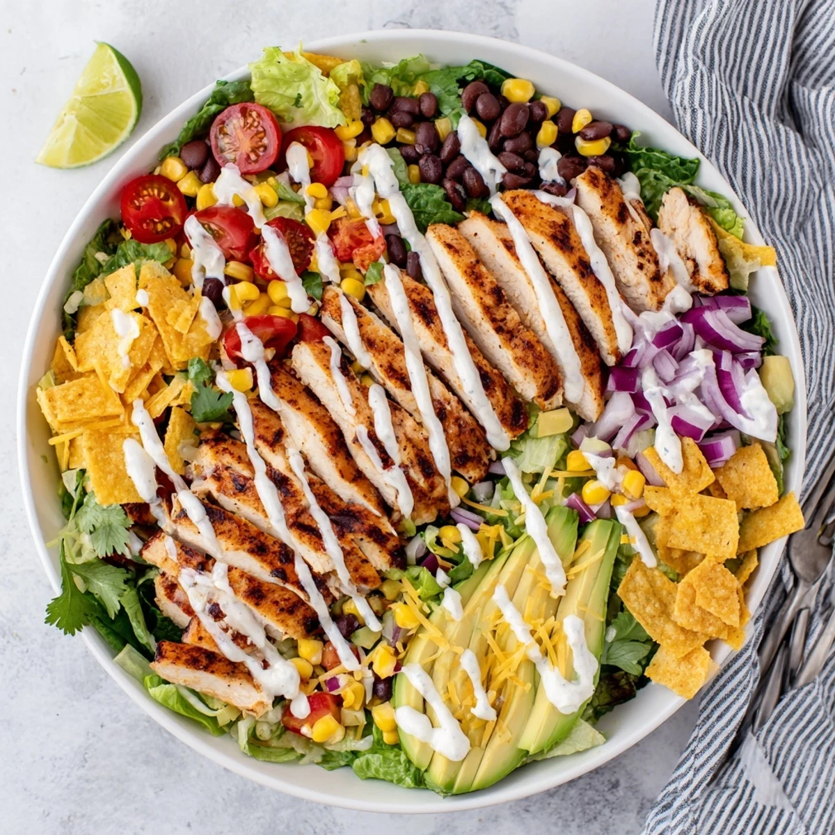 Fresh Southwest chicken salad featuring seasoned chicken breast, ripe avocado, tomatoes, and zesty yogurt lime dressing