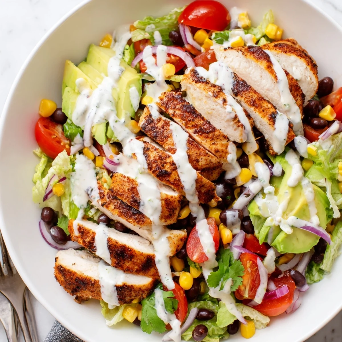 Southwestern Chicken Salad piled high with crisp greens, zesty lime cilantro dressing