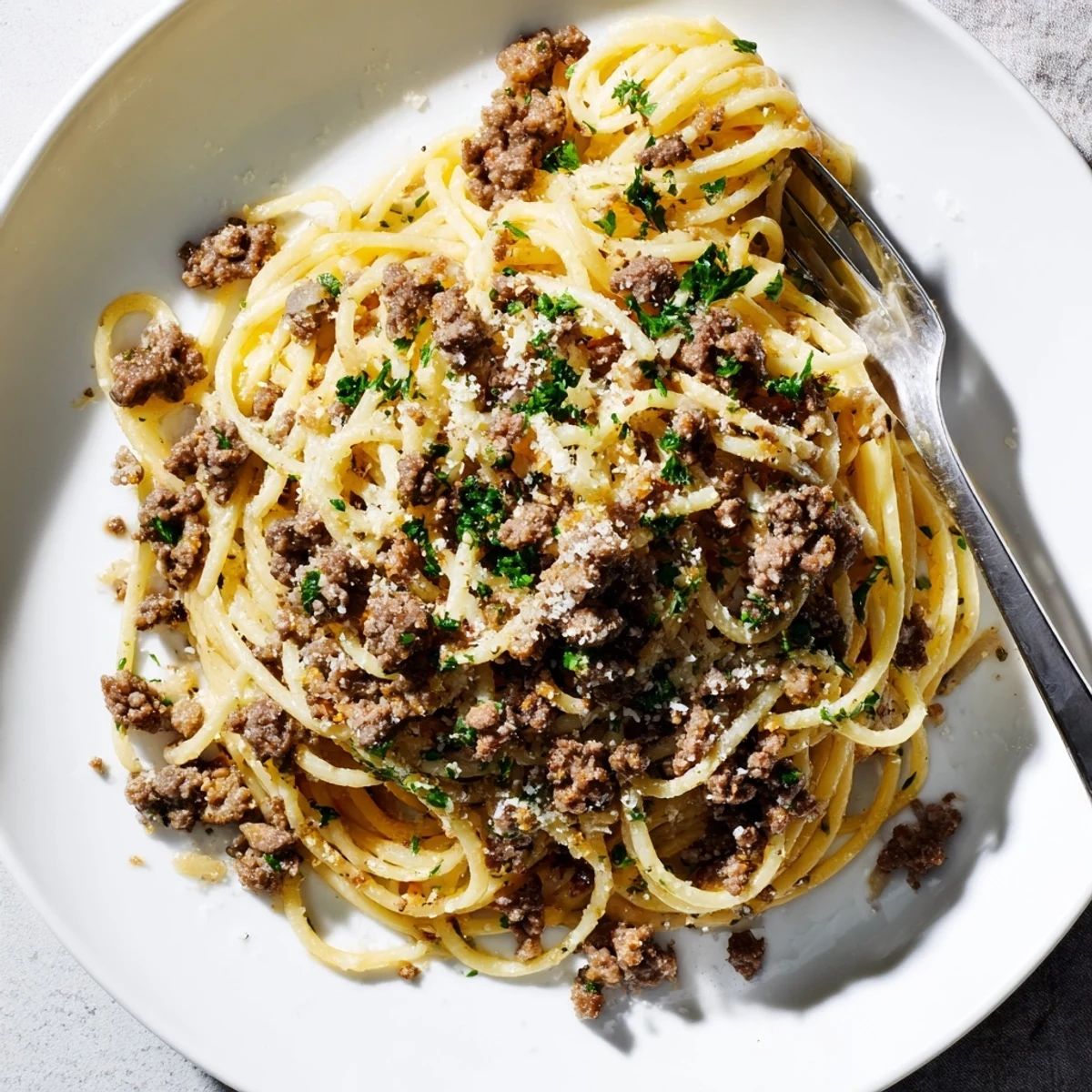 Steaming bowl of Garlic Butter Pasta With Ground Beef coated in a rich, silky garlic butter sauce