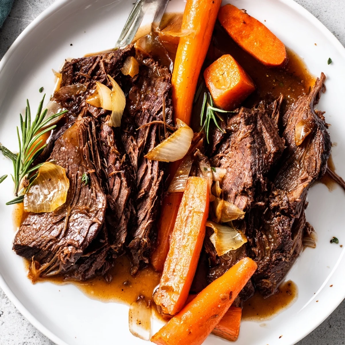 Hearty perfect pot roast plated with fork-tender beef and glossy pan juices